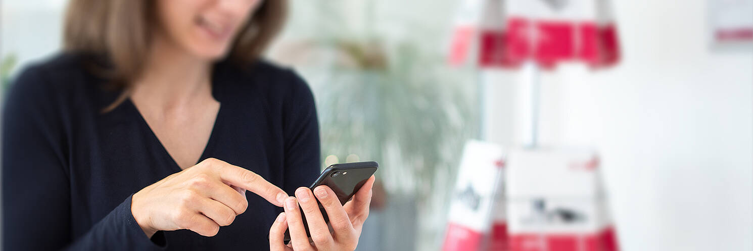 Woman taps on smartphone