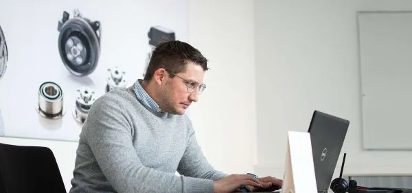 Man sitting at desk and working on his notebook
