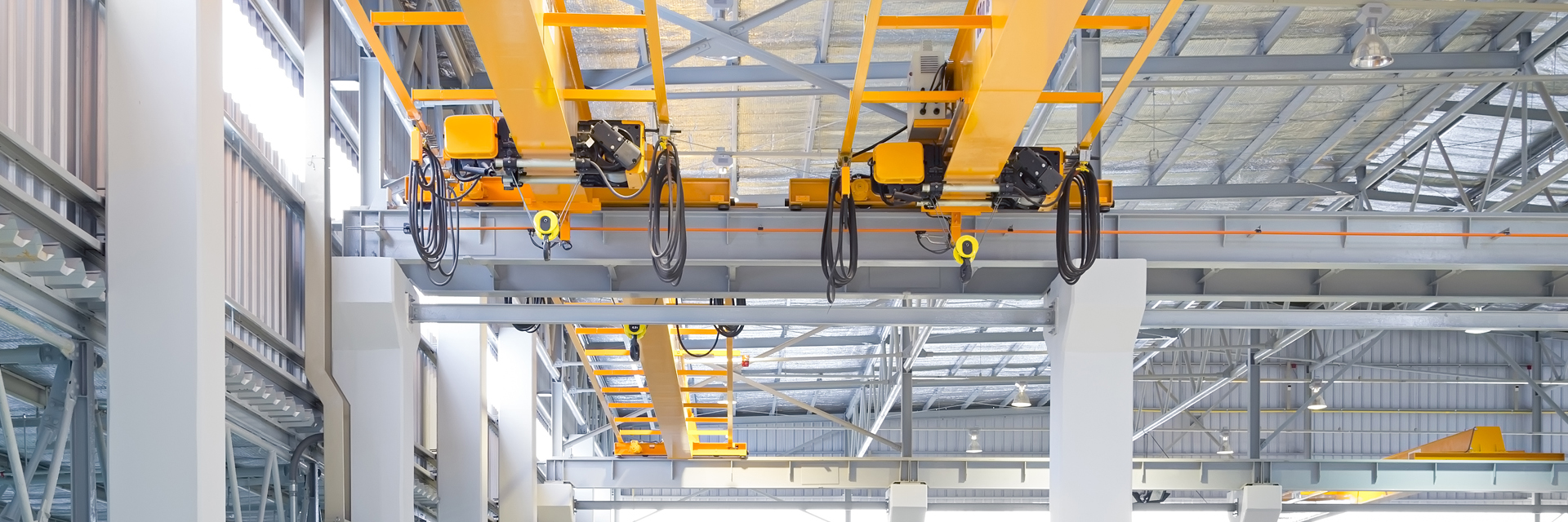Yellow crane system in industrial hall