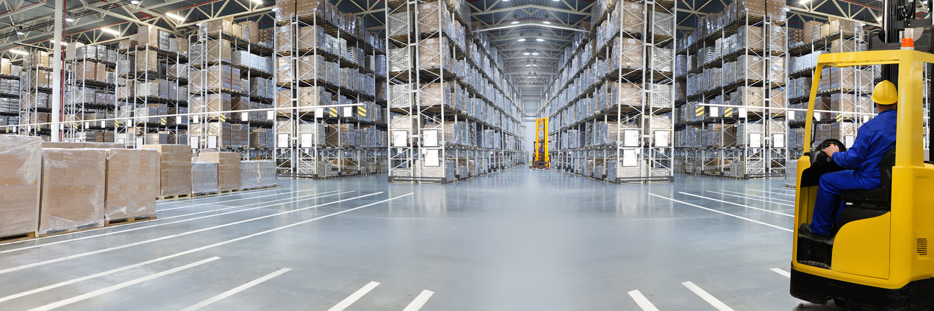 High-lift trucks in the high-bay warehouse